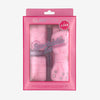 Glampton Spa Tacular set packaging with pink plush headband and wristbands in a box on a soft gray background