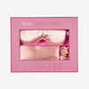 Glampton Satin Sleep Set in Peach featuring the pillowcase eye mask and scrunchie inside the closed box