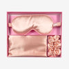 Glampton Satin Sleep Set in Peach with the pillowcase eye mask and scrunchies displayed inside the open box