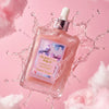 A bottle of Glampton sweet sugar body oil bottle with a pink cotton candy as a cloud on a pink background