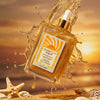 A bottle of Glampton Vanilla Sun Musk body oil with a sunset background